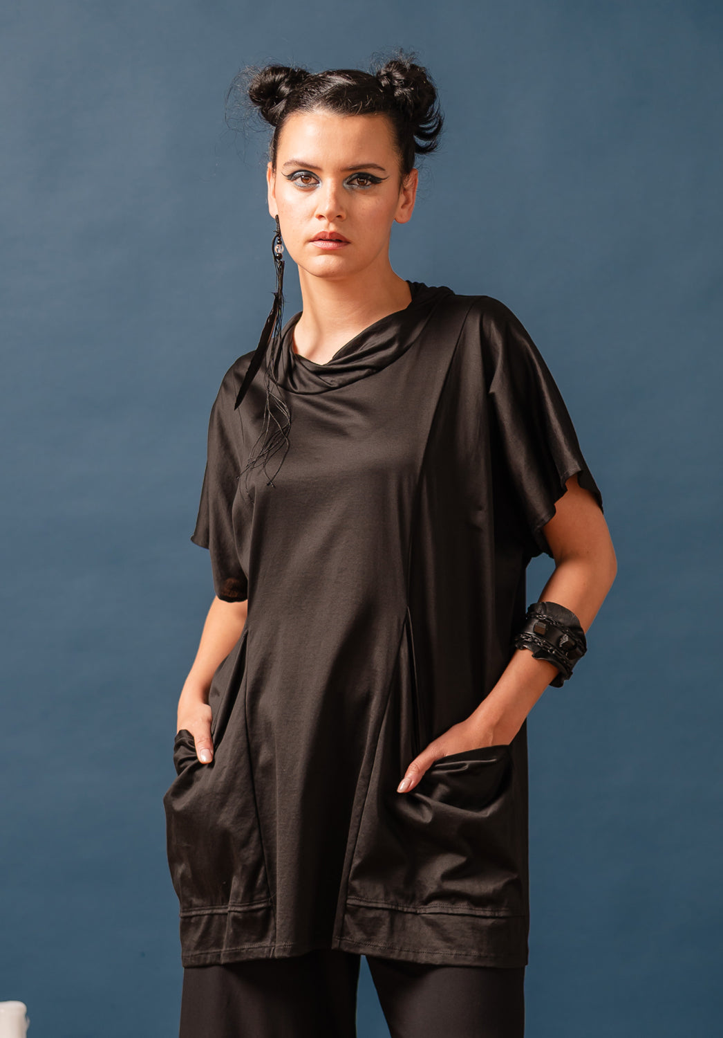 Woman wearing a black dress against a blue background