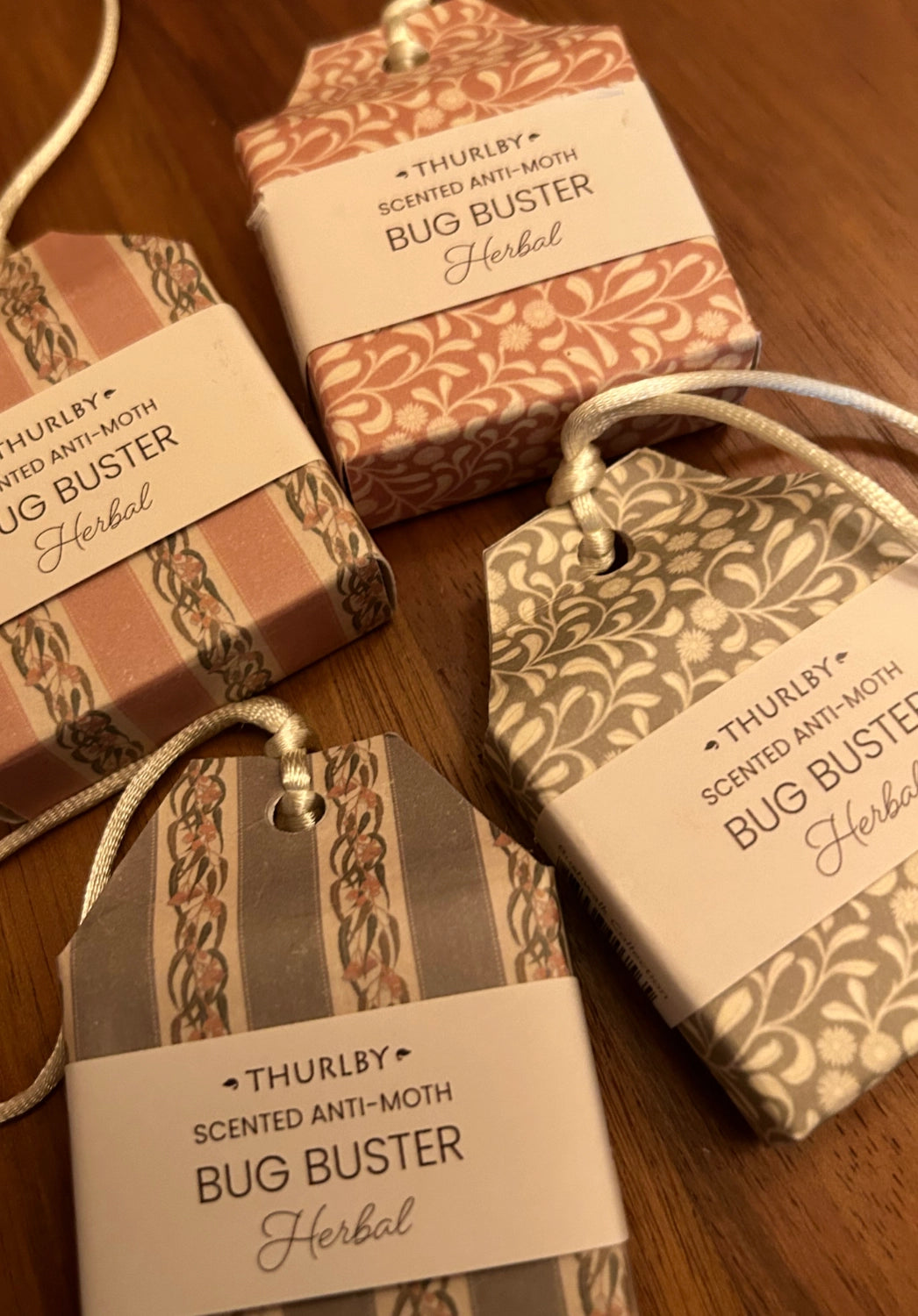 Two Thurlby scented anti-moth bug buster boxes on a wooden surface.