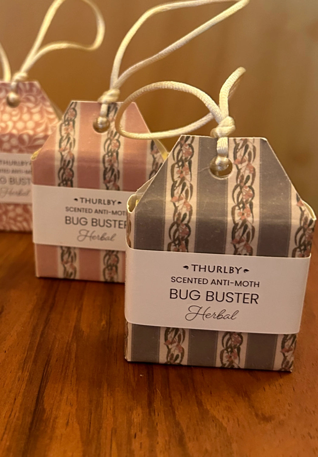 Two Thurlby scented anti-moth bug buster boxes on a wooden surface.