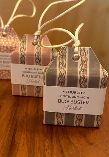 Two Thurlby scented anti-moth bug buster boxes on a wooden surface.