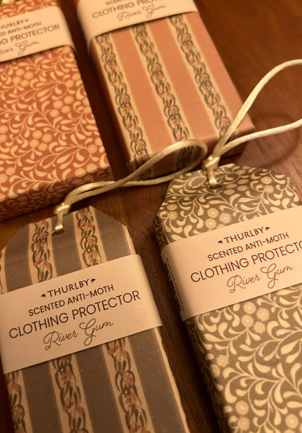 Three boxes of Thurlby scented anti-moth clothing protector on a wooden surface.