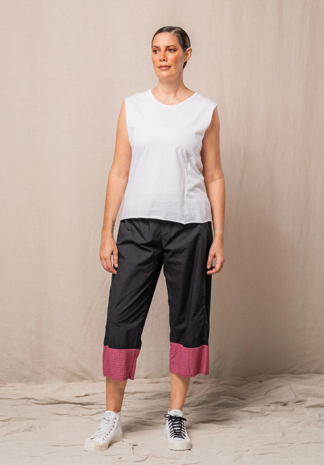 black pants made in australia with a red checked band