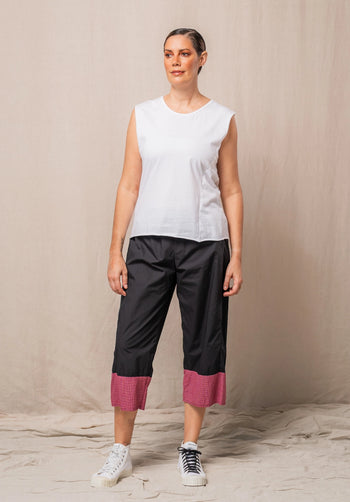 black pants made in australia with a red checked band