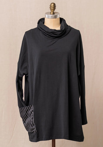 Black long-sleeve top with a cowl neck on a mannequin against a beige background